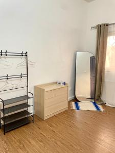 a dressing room with a mirror and a dresser at Casamigos Cosy one bedroom appartment in Dakar