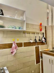a kitchen with a brick wall with utensils at Casamigos Cosy one bedroom appartment in Dakar