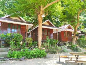 a house with a table in front of it at TipThong Hut - Tropic Garden Resort in Rayong