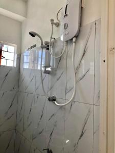 a shower head on a wall in a bathroom at Elatap Studio Overlooking Baguio in Baguio