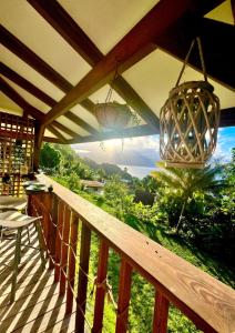 a balcony with a view of the mountains at Les Chalets de Afaahiti - Fare Keanu in Tiitau
