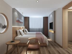 a hotel room with a bed and a tv at Happy Dragon Universal Vacation Hotel - close to Universal Studio and Wanda Plaza,free shuttle to the Resort,Free Coffee,Laundry in Beijing