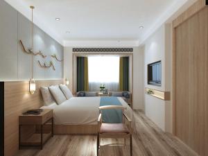 a bedroom with a bed and a desk and a tv at Happy Dragon Universal Vacation Hotel - close to Universal Studio and Wanda Plaza,free shuttle to the Resort,Free Coffee,Laundry in Beijing