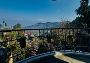 a balcony with a view of a city at Mountain View homestay in Darjeeling +15 photos