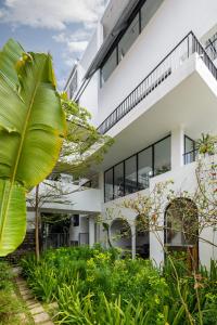 an external view of a building with plants at D'Mai Xanh Boutique Hotel Da Lat in Da Lat