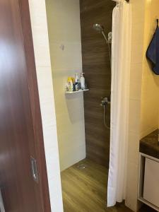 a shower in a bathroom with a shower curtain at Apartment Nagoya Thamrin favehotel in Nagoya +8 photos