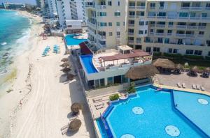 an aerial view of a resort with a beach and buildings at “Magic Sunrise at Cancun” in Cancún
