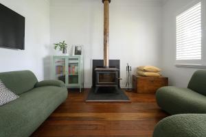 a living room with two couches and a fireplace at Karri Cove By Swan Bnb Management in Denmark