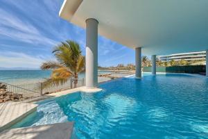 a swimming pool with a view of the ocean at Beach home in Bucerías