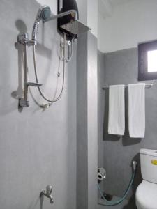 a bathroom with a shower and a toilet and towels at Penthouse Galle in Galle +59 photos