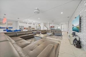 a large living room with couches and a tv at The Bling Estate in Kissimmee