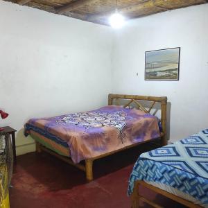 Ένα ή περισσότερα κρεβάτια σε δωμάτιο στο Wasi Center Homestay Holistic and Mystic