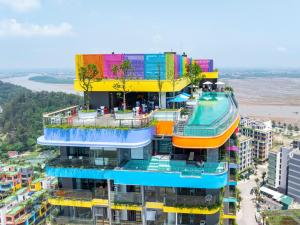 a building with a pool on top of it at Flamingo1 Ibiza Hai Tien in Nam Khê