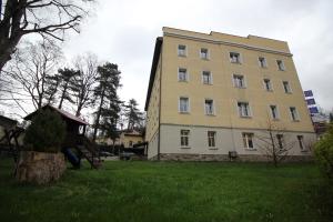 un gran edificio amarillo en un campo de césped en Ośrodek Wypoczynkowy HEL, en Lądek-Zdrój