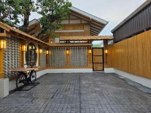 un patio con tavolo e un edificio di Baan Prod Pool Villa Chiang Mai a Chiang Mai