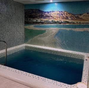 a swimming pool with a mural of a desert at Moyenne Apart Hotel in Rivne