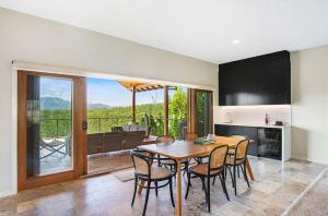 a kitchen and dining room with a table and chairs at Myava - By Berry Getaways in Berry
