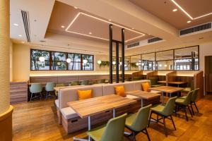 a restaurant with wooden tables and chairs at Richmond Hotel Hamamatsu in Hamamatsu +22 photos