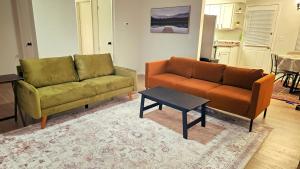 a living room with two couches and a coffee table at Comfort By the Bay Close to Mobile International Airport in Mobile +3 photos