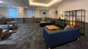 a lobby with couches and tables in a room at Richmond Hotel Hamamatsu in Hamamatsu