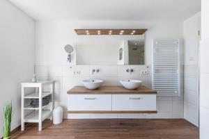 un bagno con due lavandini e uno specchio di Haus Am Meer Familie Frener a Pellworm Altre 55 foto
