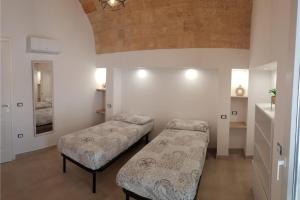 a bedroom with two beds in a room at Villa Pescoluse with Pool and Sea View - Happy Rentals in Salve