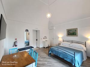 a bedroom with a bed and a table at Regina Margherita in Positano
