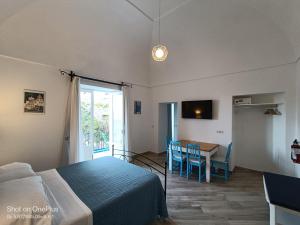 a bedroom with a bed and a table and a dining room at Regina Margherita in Positano