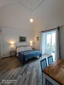 a bedroom with a bed and a table at Regina Margherita in Positano