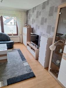 a living room with a couch and a refrigerator at Ferienwohnung am Koptischem Kloster in Höxter