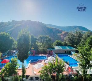a view of a resort with two swimming pools at HUMSON BULOQ SANATORIUM in Khumson