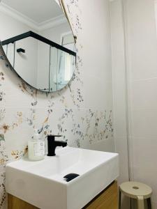 a bathroom with a white sink and a mirror at Chipiona Center in Chipiona +37 photos