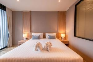 Postel nebo postele na pokoji v ubytování Carrara Hotel Hatyai