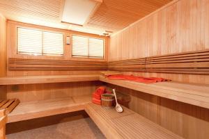 a sauna with wooden walls and benches and a window at Hotel Atlantic Juist in Juist
