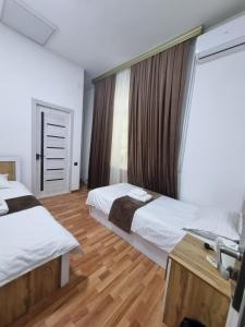 a hotel room with two beds and a window at shafranhotel in Tashkent +24 photos