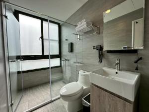 a bathroom with a toilet and a sink and a shower at Neostay in Zhubei