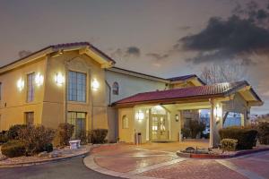 a large yellow building with a garage at night at La Quinta Inn by Wyndham Reno in Reno
