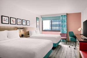 a hotel room with two beds and a window at Hilton Garden Inn LAX Los Angeles Airport in Los Angeles +86 photos
