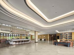 a lobby of a building with a large ceiling at Hilton Garden Inn Sanya Haitang Bay in Sanya