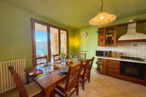 a kitchen with a wooden table and a dining room at Pianello Bellavista in Pianello Del Lario