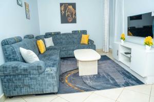 a living room with a couch and a table at Mariehomes in Thika
