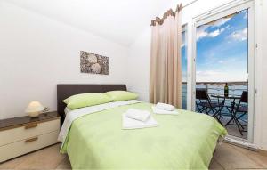 a bedroom with a large bed and a balcony at Cozy Apartment In Vidalici in Kustići