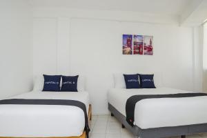 En eller flere senger på et rom på Capital O Hotel Dos Mares, Cabo San Lucas