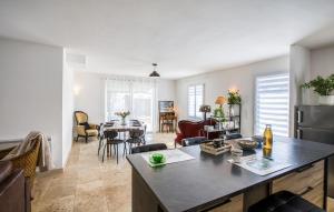 a kitchen and living room with a table and chairs at Cozy Home In Dolus-D'oléron With Wifi in Dolus-d'Oléron