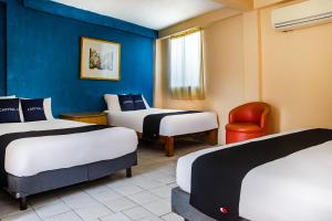 Postel nebo postele na pokoji v ubytování Capital O Hotel Dos Mares, Cabo San Lucas