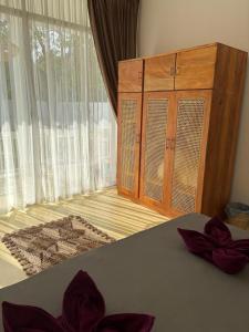a bedroom with a bed and a dresser and a window at Interlanka Coast Living in Ahangama +43 photos