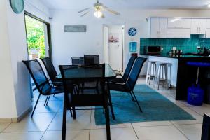 a dining room and kitchen with a table and chairs at The Zinkwazi Beach Holiday Home in Zinkwazi Beach