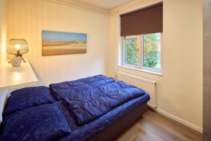 Postel nebo postele na pokoji v ubytování De Pelikaan Texel Appartementen