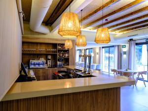 a bar in a restaurant with several lights at Hotel Rural Casa del Oso in El Oso