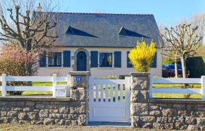 a white fence in front of a white house at Lovely Home In La Fresnais With Kitchen in La Fresnais +14 photos